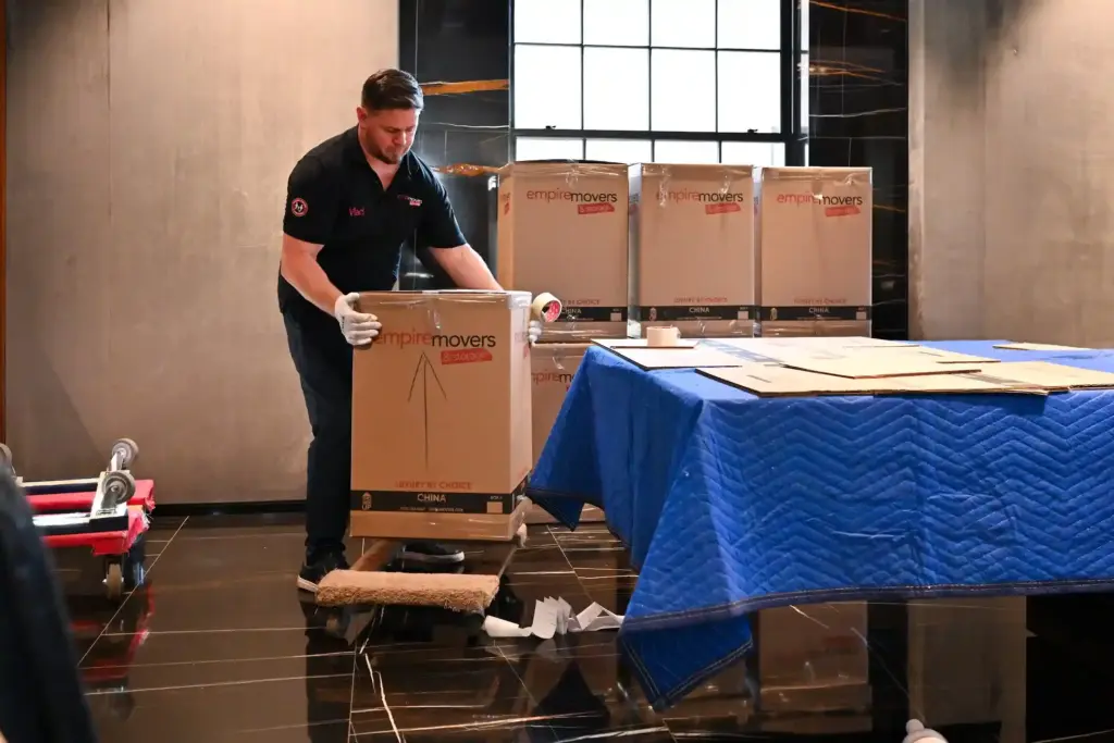 Professional NYC moving company packing and protecting boxes for a residential move with Empire Movers and Storage NYC