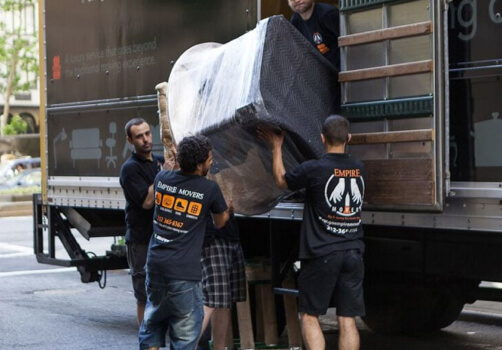 Long distance moving company Queens. Empire Movers and Storage loading the truck in Queens