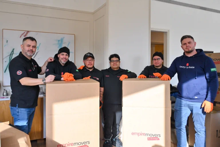 Six Empire Movers and Storage team members in the middle of the picture and the used packing materials.