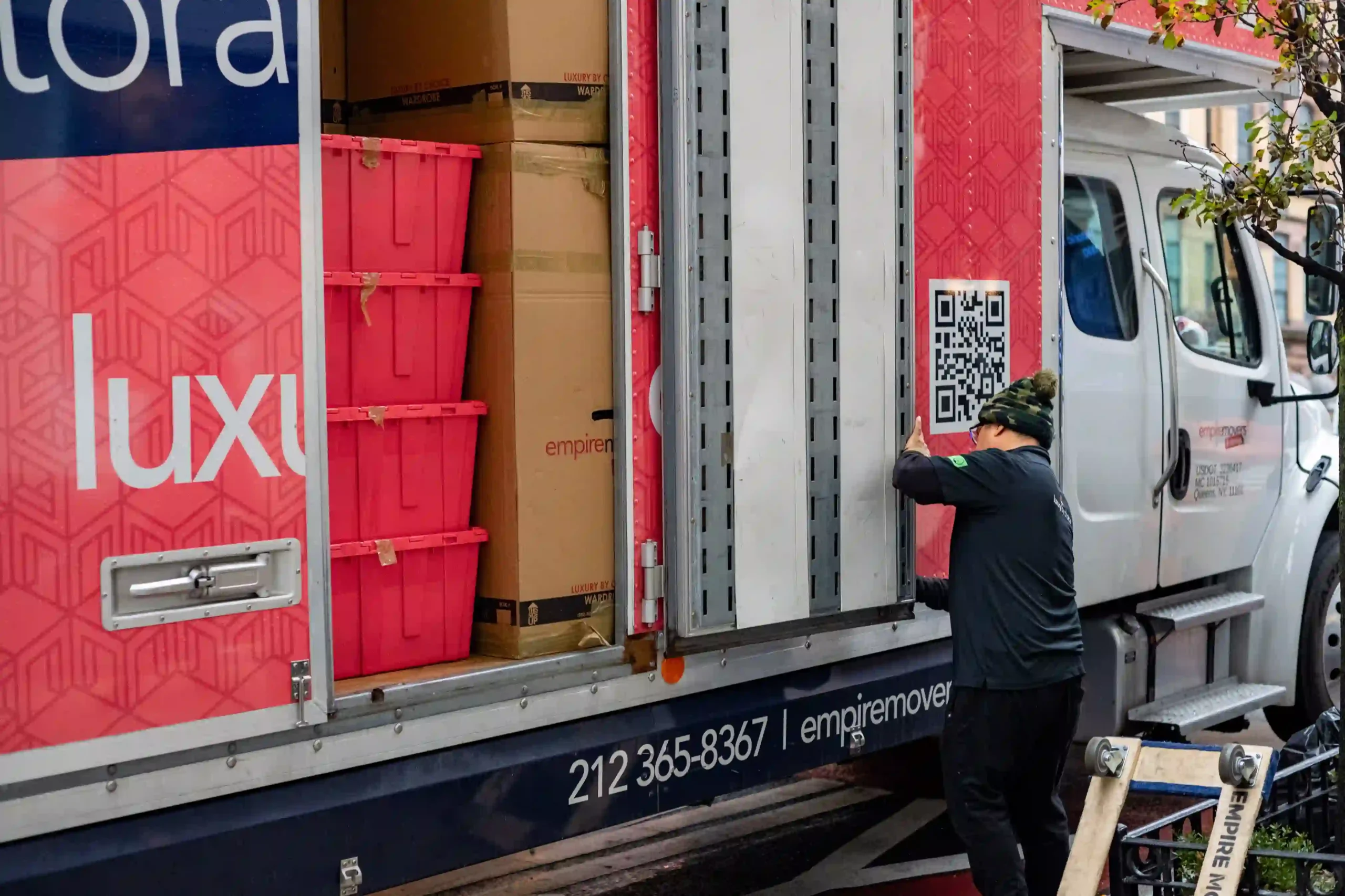 Residential moving truck of Empire Movers and Storage fully loaded in New York city.